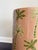 A one-of-a-kind ceramic stool by Made Goods, featuring a tropical palm motif in soft blush and layered greens. This glazed...