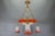 French Empire-style chandelier with a signed glass bowl and bronze swans, circa 1925. Striking chandelier featuring a red...