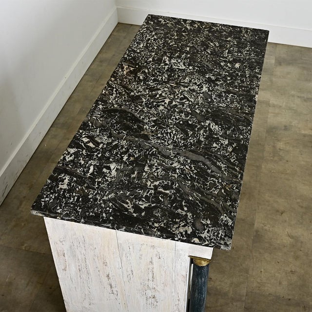 A French Empire commode from the 19th century, updated more recently with paint in layered & scraped faux finish that...