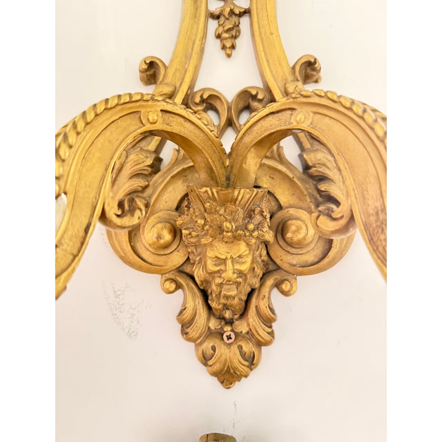 Pair of two-arm ormolu sconces, finely chased. Openwork body with palmettes, fleurons and leaves made in late 19th century...
