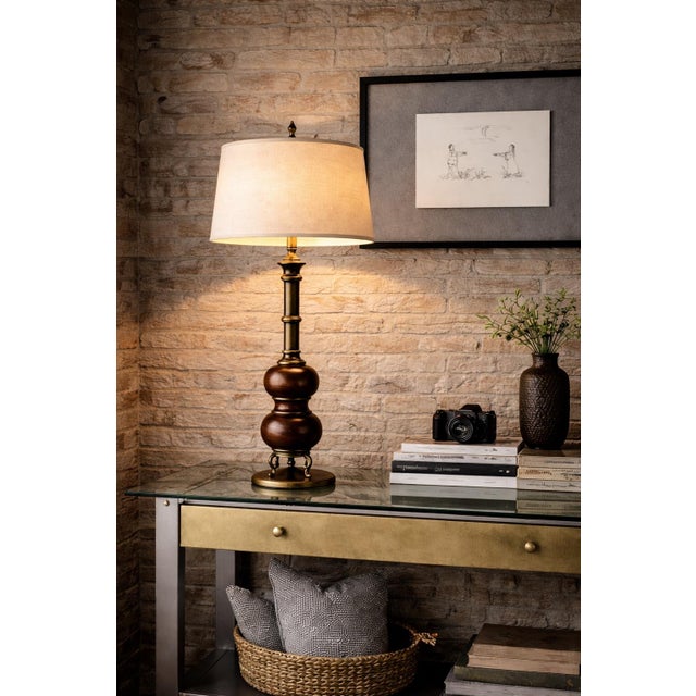 An elegant oversized table lamp showcasing a refined blend of classic form and warm material contrast, this vintage 1970s...