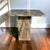 An elegant postmodern side table crafted entirely in Cipollino Ondulato marble, showcasing dramatic, ribbon-like veining...