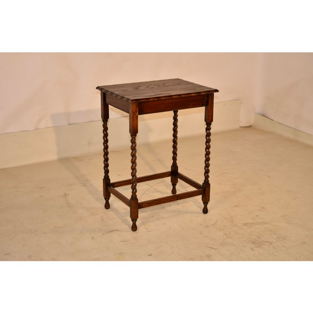 Period Edwardian oak side table from England, circa 1900. This table has lovely graining tot he top, surrounded by a...