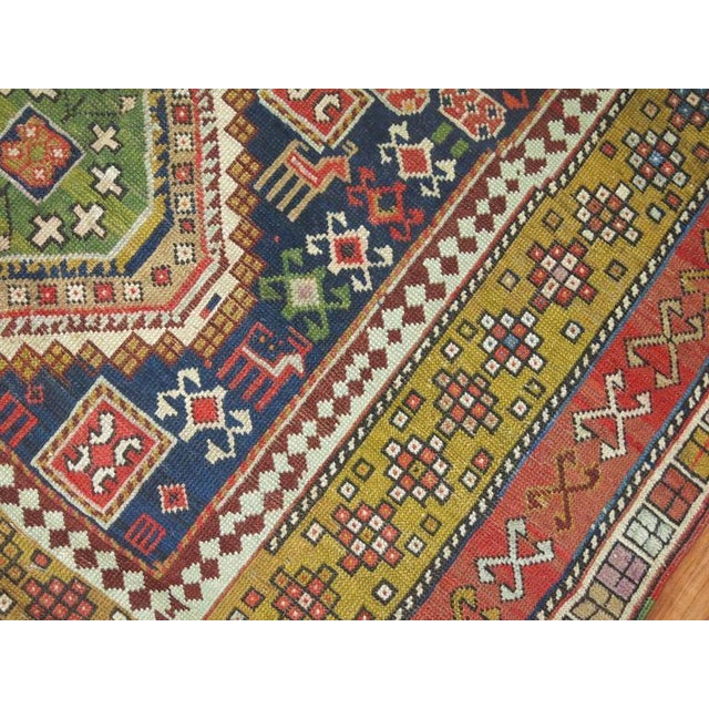 An early 20th century Shirvan rug woven in the villages of the Caucuses. 5 colorful medallions on a navy ground....