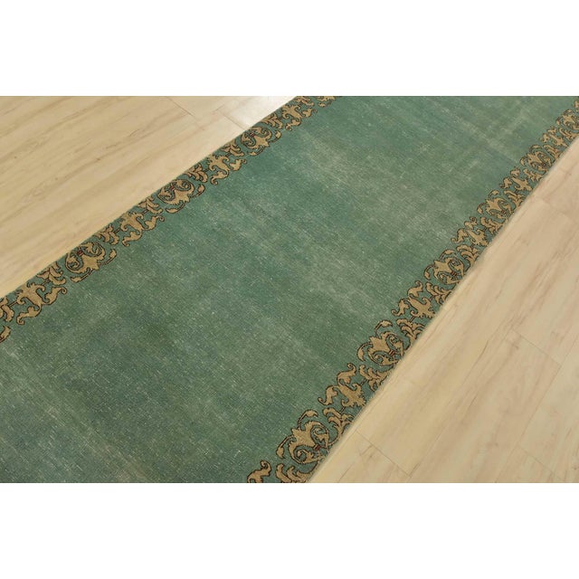 An authentic vintage traditional Tabriz runner hand-knotted with fine wool and natural dyes. This rug features a solid...