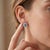 Capture the icy brilliance of clear blue skies with these breathtaking oval halo stud earrings. Centered around a vibrant...