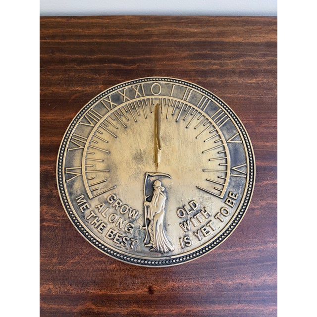 A stunning vintage brass garden sundial reading "Grow old along with me. The best is yet to be." USA, Late 20th Century...