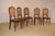 Circa 1900 set of five Louis XVI style chairs made from walnut. The curved backs have molded frames and have hand cast...