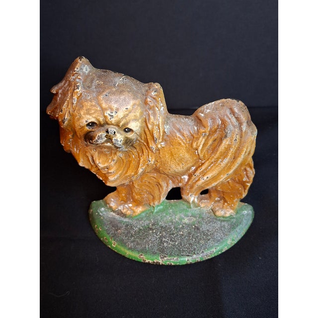 Up for sale is a rare and substantial original early 20th-century cast iron Pekingese dog paperweight / shelf sculpture...