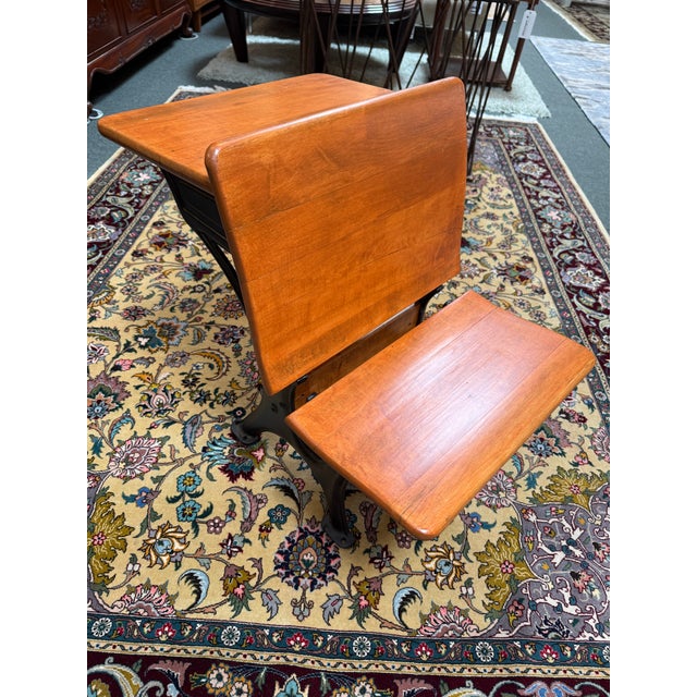Design Plus Gallery presents a 1920’s School Desk. The desk has a single seat that has a desk attached to the back. It is...