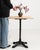 An authentic French bistro table combining a sturdy cast iron base with a warm oak top. The contrast of materials creates...