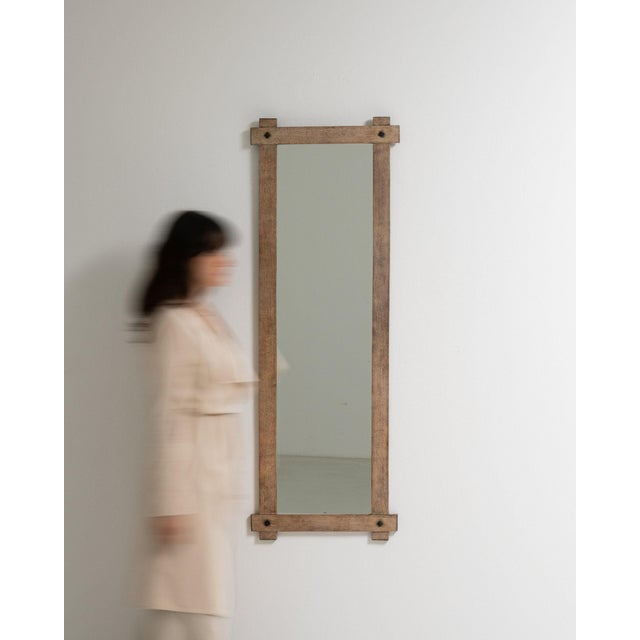 Here is a mirror, its natural weathered oak frame, tall narrow the first thing to catch the eye. The piece dates to 1970s,...
