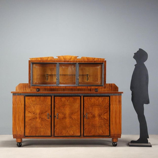 Art Deco sideboard made of walnut and walnut burl, from Italy in the second quarter of the 20th century. The backsplash is...