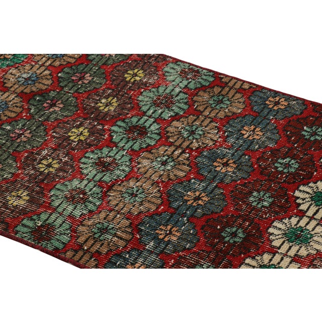 Hand-knotted in wool and originating from Turkey circa 1960 – 1970, this 2x5 vintage Zeki Müren runner is a unique...