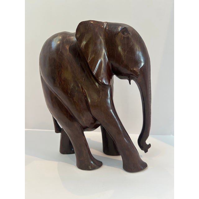A beautifully sculptural hand-carved African elephant in richly toned kiaat hardwood, likely originating from southern...
