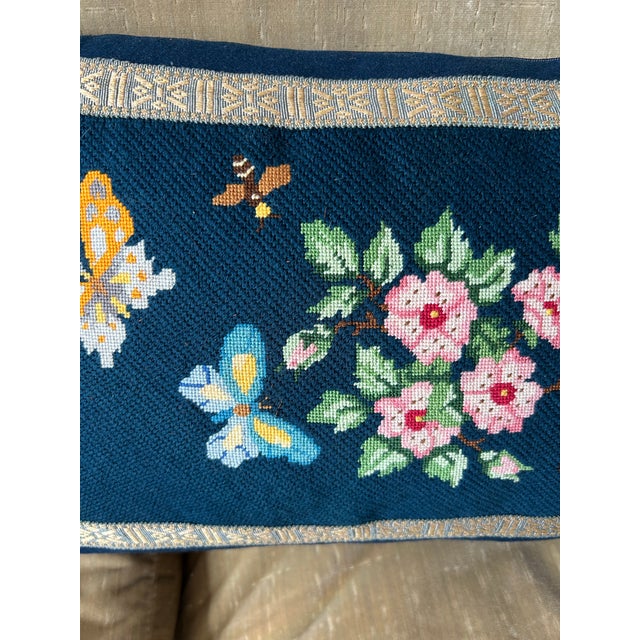 A hand worked needlepoint pillow with a charming floral and fauna scene. 2 are available