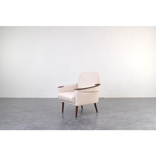 This armchair was manufactured in Germany in the 1960s. Armrests of chair was made of solid oak wood and legs made of...