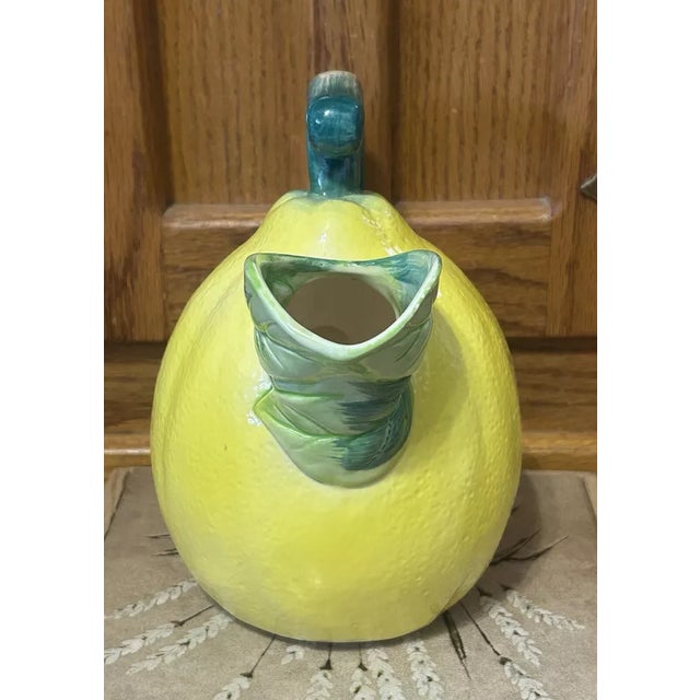 Brighten your table or kitchen display with this charming figural ceramic lemon pitcher by The Haldon Group. Expertly...