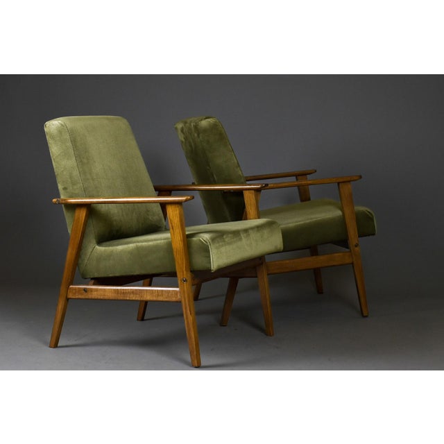 This elegant pair of mid-century modern armchairs was produced in Poland in the 1970s and 1980s. Originally designed in...