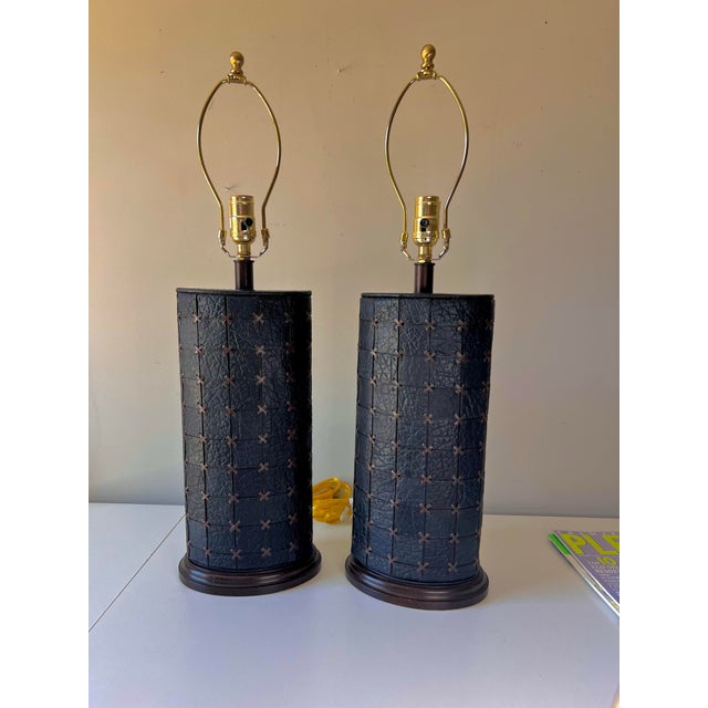 Pair of two unique vintage black leather patchwork table lamps with brown leather cross stitching. Wonderful oval shape.