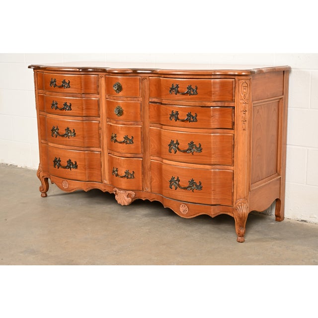 A beautiful French Provincial Louis XV style twelve-drawer triple dresser or chest of drawers By Kent Coffey USA, Circa...