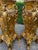A decorative pair of 1990s Italian Baroque-style pedestals, crafted in resin with a rich gilded finish and dark marble-...