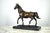 A 20th century bronze horse on a marble base. A very well cast and chased trotting horse, upon the cast bronze turf...