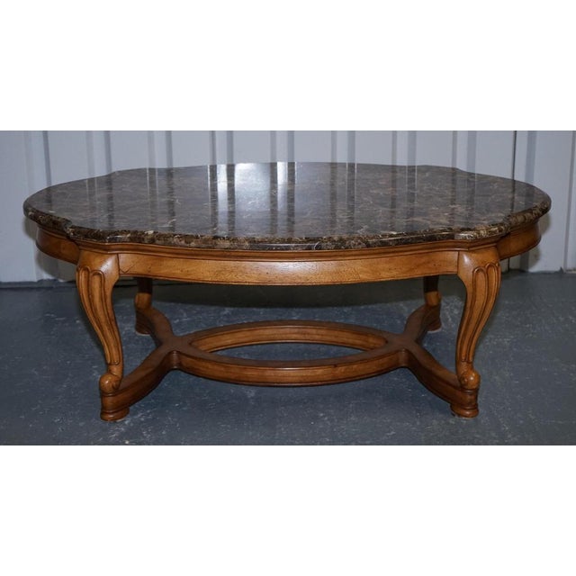 This elegant vintage coffee table is crafted in a refined French style, combining graceful lines with a beautifully...