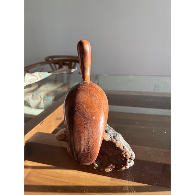 Quirky and beautiful pelican carving with the smooth bird juxtaposed against his rough perch. He spins so is adjustable....