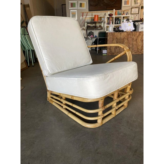 Unique three-strand square pretzel rattan asymmetric lounge chair with an open side and one chair arm design. 1950, United...