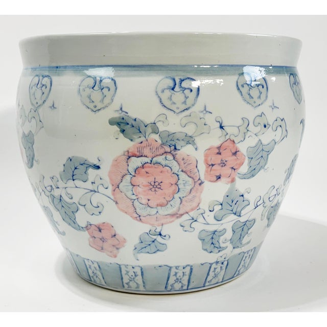 Oversized vintage planter in pastel tones of pink, blue and green with detailed floral motif. No chips or cracks. Age wear.