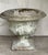 A substantial mid-century cast stone garden urn with classical fluted body and square plinth base. The surface shows...