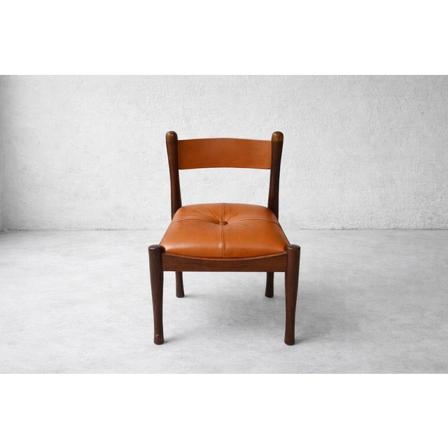 Set of six chairs designed by Silvio Coppola for Bernini in the 1960s. The seat is in cognac-colored padded leather, the...