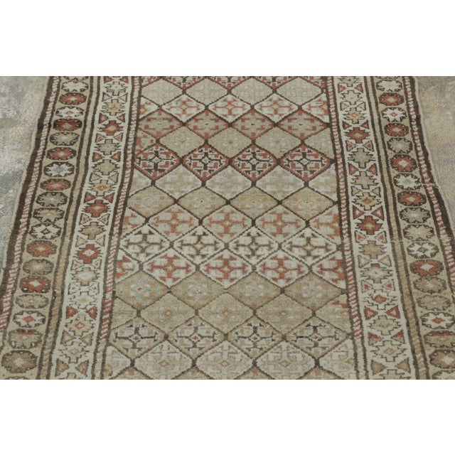 This vintage 3x9 antique Kurdish runner from Persia is a finely hand-knotted wool rug that embodies the rich heritage of...
