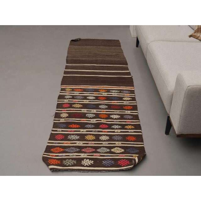 Vintage Hand-Knotted runner rug is a semi-antique vintage kilim runner rug. The '70s Eastern region of Anatolia's unique...