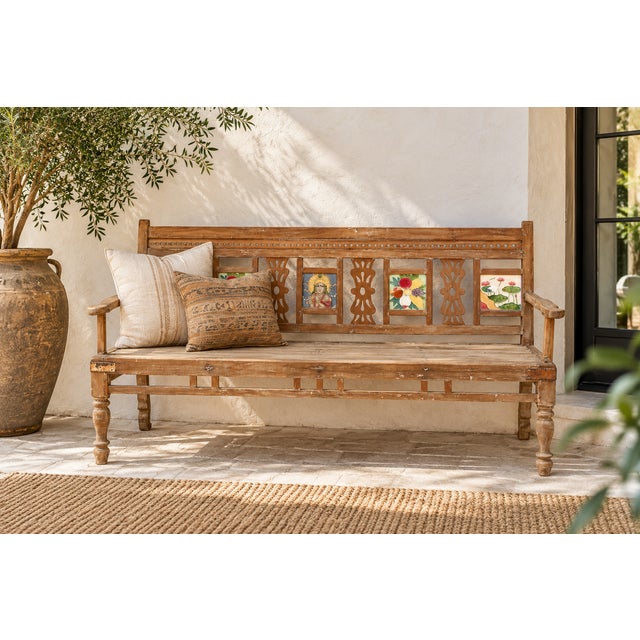 Painted tiles march across the back of this antique Indian teak bench, no two alike: a bloom here, a geometric star there,...