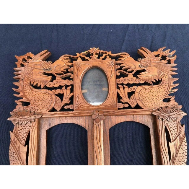 ANTIQUE CHINESE CARVED WOOD PICTURE FRAME WITH DRAGONS IN VERY GOOD ESTATE CONDITION. There are a couple minor chips which...