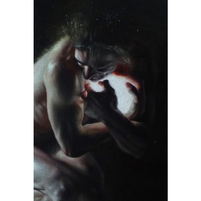 The artwork depicts a solitary figure in a dramatic pose, cradling a luminous orb against a dark, atmospheric backdrop....