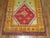 A Turkish Tulu prayer rug with saturated colors in predominant red. Lime green and orange tones Measures: 4' x 4'9".