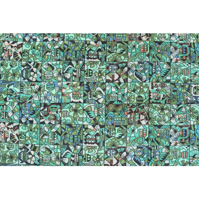 This vintage rug from Vorwerk feature Paul Klee inspired motifs. It is made of wool in warm colors with geometric decoration.