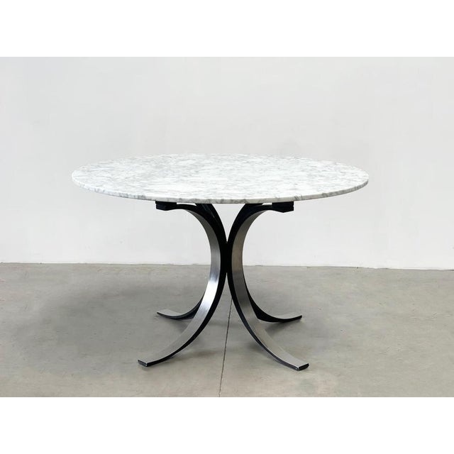 Gorgeous vintage dining table model T69 designed by Osvaldo Borsani made from a brushed metal and black coated base and a...