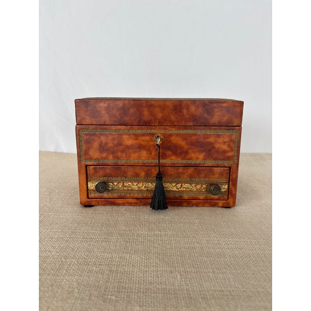 Vintage 1970s, Florentine gold embossed mottled tan/brown smooth leather wrapped wood Jewelry Box with Key. This cube-...