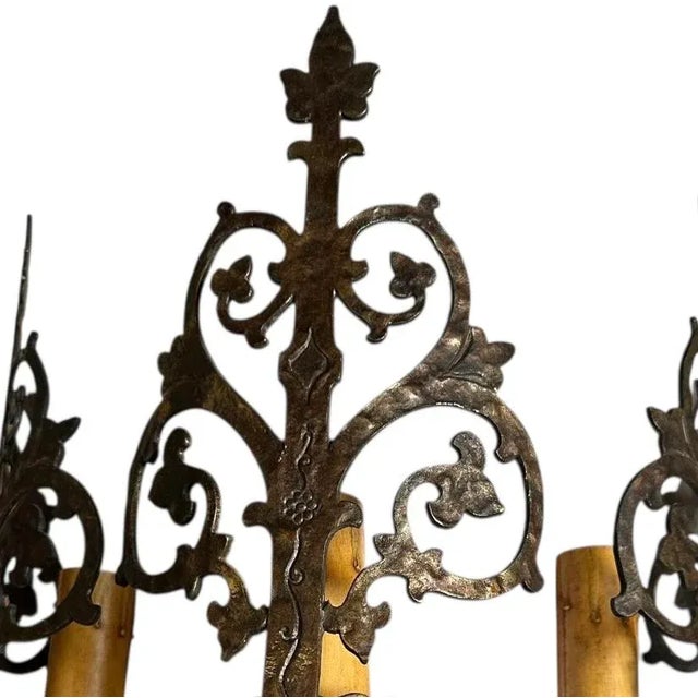 This chandelier is of the Spanish/Tudor Revival period. Intricate scrollwork and a foliage motif give this light a lot of...