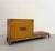 A gorgeous platform credenza featuring clean architectural lines and an asymmetrical integrated base. Crafted in a warm...