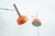 Minimalist Minilux (Type 35) wall lights in orange, designed by Rosemarie and Rico Baltensweiler in the 1960s and...