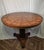 An exceptional round pedestal dining table by luxury furniture maker Theodore Alexander, featuring an intricately...