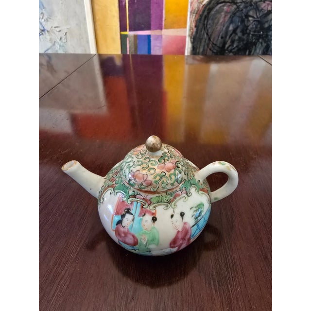 A superb extra fine quality antique chinese porcelain diminutive miniature tea pot . Having percision detailed enamel...