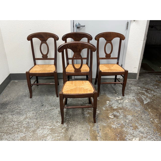 Design Plus Gallery presents a Set of Four Napoleon Dining Chairs from Pottery Barn. Each chair has a wood frame, a curved...
