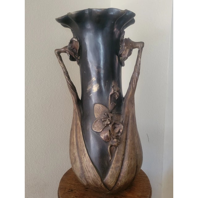 One of a kind, two tone tall bronze vase with a scalloped floral motif opening. The center of the vase in on an ebony...