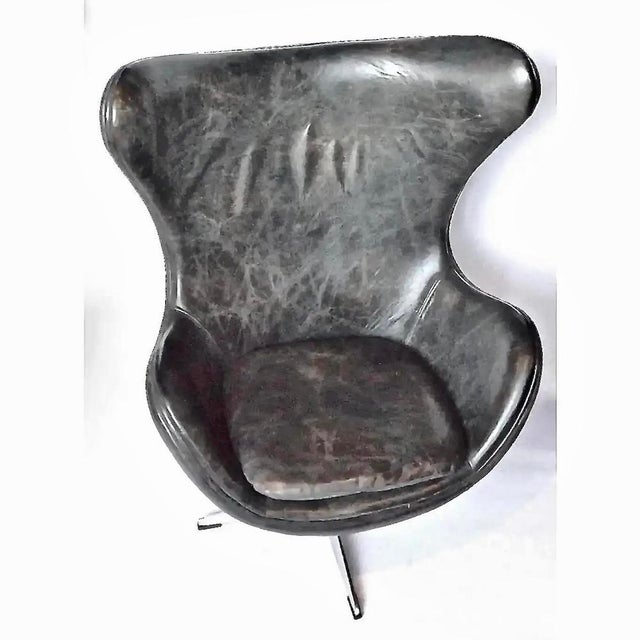 Vintage Mid-Century Modern leather chair with removable seat cushion and steel cross brace foot. Classic piece of Mid-...
